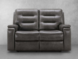 A Black leather reclining sofa is prominently displayed in the image, showcasing its elegant design and comfort
